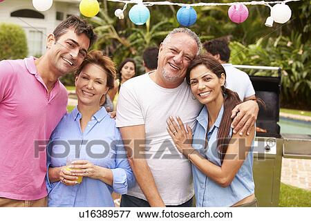 Stock Photo - Parent With Adult Children Enjoying Party In Garden . Fotosearch