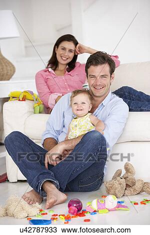 Parents at home with baby girl View Large Photo Image Stock Image - Parents at home with baby girl. Fotosearch