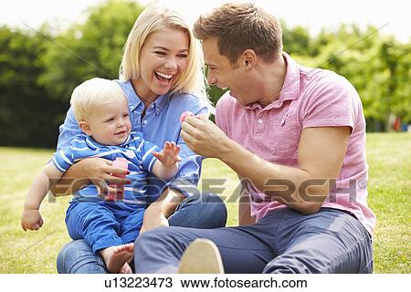 Parents Blowing Bubbles For Young Boy In Garden View Large Photo Image Stock Image - Parents Blowing Bubbles For Young Boy In Garden. Fotosearch