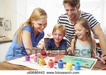 Stock Image - Parents Painting Picture With Children At Home. Fotosearch