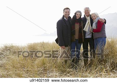 Parents With Adult Offspring Standing In Dunes View Large Photo Image Stock Photo - Parents With Adult Offspring Standing In Dunes. Fotosearch