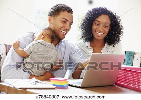 Parents With Baby Working In Office At Home View Large Photo Image Stock Photo - Parents With Baby Working In Office At Home. Fotosearch