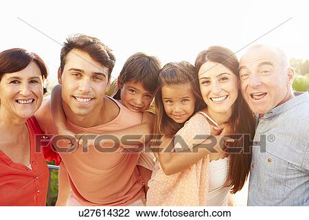 Parents With Grandparents Giving Children Piggyback Ride View Large Photo Image Stock Image - Parents With Grandparents Giving Children Piggyback Ride. Fotosearch
