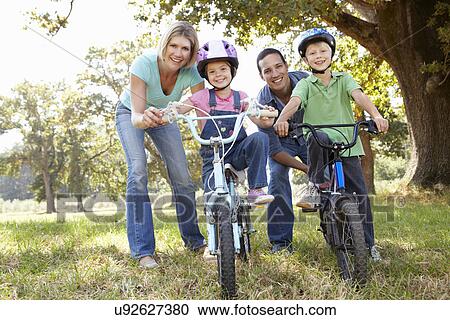 Parents with young children on bikes View Large Photo Image Stock Image - Parents with young children on bikes. Fotosearch