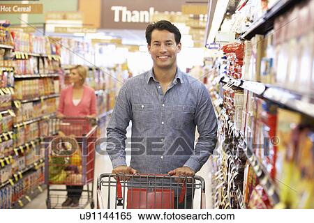 Stock Photography - People shopping in supermarket. Fotosearch