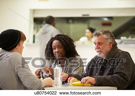 People Sitting At Table Eating Food In Homeless Shelter View Large Photo Image Stock Image - People Sitting At Table Eating Food In Homeless Shelter. Fotosearch