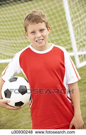 Portrait boy in soccer kit with ball View Large Photo Image Stock Photo - Portrait boy in soccer kit with ball. Fotosearch