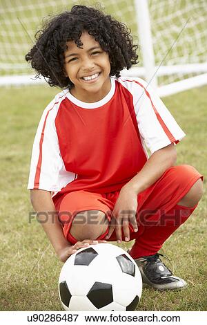 Portrait boy in soccer kit with ball View Large Photo Image Stock Photo - Portrait boy in soccer kit with ball. Fotosearch