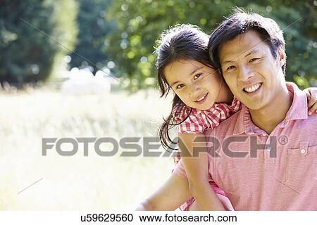 Stock Image - Portrait Of Asian Father And Daughter In Countryside. Fotosearch
