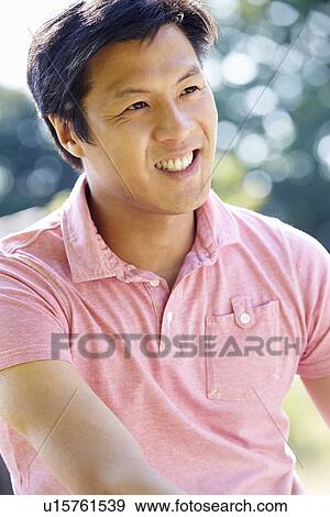 Stock Photo - Portrait Of Asian Man In Countryside. Fotosearch
