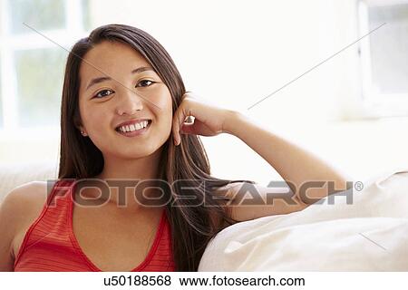 Portrait Of Asian Woman Relaxing Sitting On Sofa View Large Photo Image Stock Photo - Portrait Of Asian Woman Relaxing Sitting On Sofa. Fotosearch
