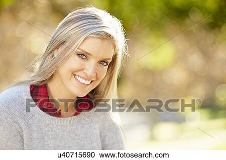 Stock Image - Portrait Of Attractive Woman In Countryside. Fotosearch