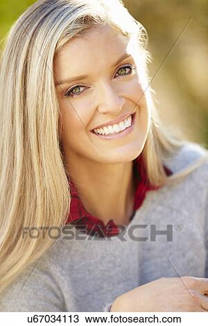 Stock Image - Portrait Of Attractive Woman In Countryside. Fotosearch