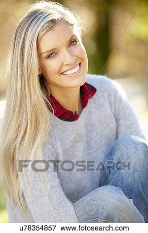 Stock Photo - Portrait Of Attractive Woman In Countryside. Fotosearch