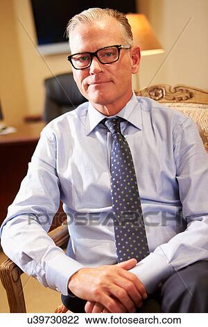 Portrait Of Businessman Sitting In Chair View Large Photo Image Stock Image - Portrait Of Businessman Sitting In Chair. Fotosearch