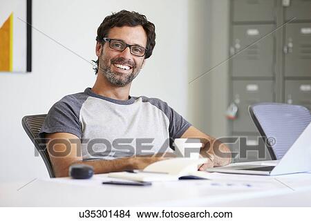 Picture - Portrait Of Casually Dressed Man Working In Design Studio. Fotosearch