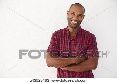 Portrait Of Casually Dressed Man Leaning Against White Wall View Large Photo Image Stock Image - Portrait Of Casually Dressed Man Leaning Against White Wall. Fotosearch