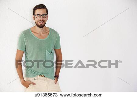 Portrait Of Casually Dressed Man Leaning Against White Wall View Large Photo Image Stock Image - Portrait Of Casually Dressed Man Leaning Against White Wall. Fotosearch