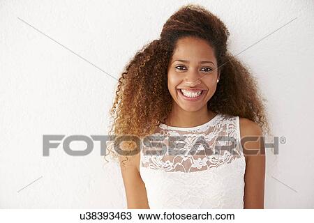 Stock Image - Portrait Of Casually Dressed Woman Leaning Against Wall. Fotosearch