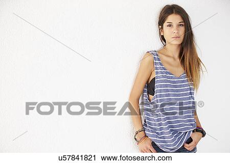 Stock Image - Portrait Of Casually Dressed Woman Leaning Against Wall. Fotosearch