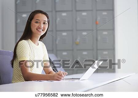 Stock Image - Portrait Of Casually Dressed Woman Working In Design Studio. Fotosearch