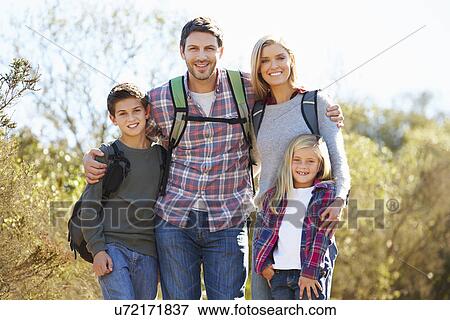 Portrait Of Family Hiking In Countryside Wearing Backpacks View Large Photo Image Stock Photo - Portrait Of Family Hiking In Countryside Wearing Backpacks. Fotosearch