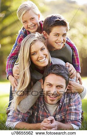 Portrait Of Family Lying On Grass In Countryside View Large Photo Image Stock Image - Portrait Of Family Lying On Grass In Countryside. Fotosearch