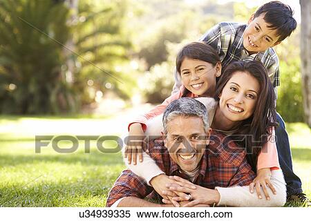 Portrait Of Family Lying On Grass In Countryside View Large Photo Image Stock Photography - Portrait Of Family Lying On Grass In Countryside. Fotosearch