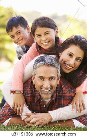 Portrait Of Family Lying On Grass In Countryside View Large Photo Image Stock Photography - Portrait Of Family Lying On Grass In Countryside. Fotosearch