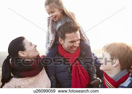 Stock Photo - Portrait Of Family On Winter Beach. Fotosearch