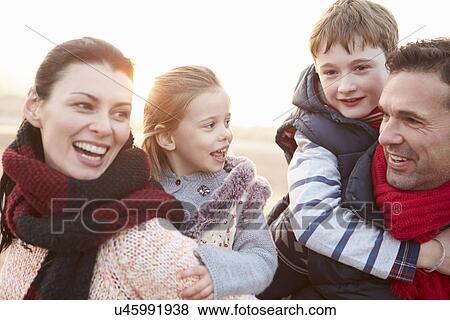Stock Photo - Portrait Of Family On Winter Beach. Fotosearch