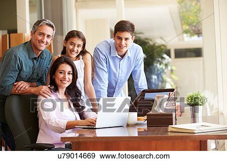 Stock Photo - Portrait Of Family Using Laptop Together. Fotosearch