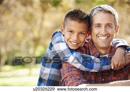 Stock Photo - Portrait Of Father And Son In Countryside. Fotosearch