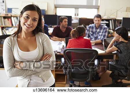 Portrait Of Female Architect With Meeting In Background View Large Photo Image Picture - Portrait Of Female Architect With Meeting In Background. Fotosearch