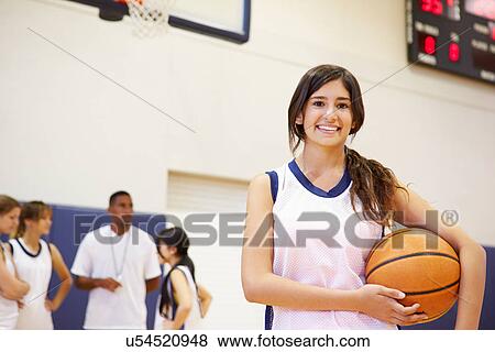 Stock Photo - Portrait Of Female High School Basketball Player. Fotosearch