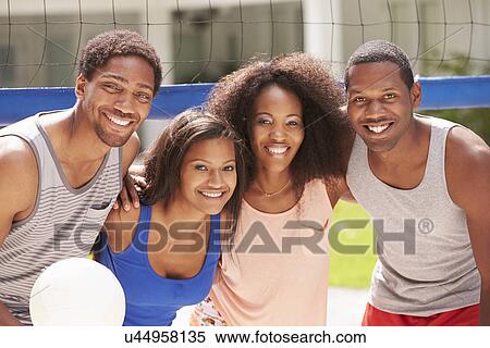 Stock Photography - Portrait Of Friends Playing Volleyball Match. Fotosearch