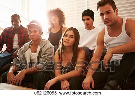 Stock Photography - Portrait Of Gang Members Sitting On Sofa In House. Fotosearch