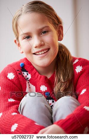 Stock Photo - Portrait Of Girl Wearing Christmas Jumper. Fotosearch