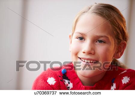 Stock Photo - Portrait Of Girl Wearing Christmas Jumper. Fotosearch