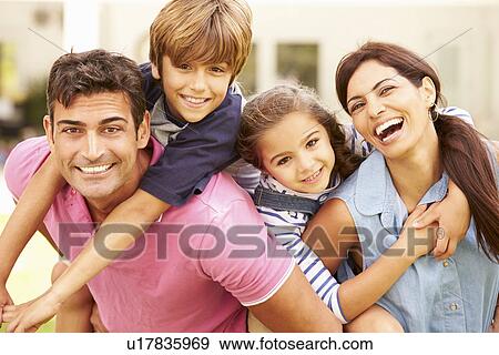 Stock Photo - Portrait Of Happy Family In Garden At Home. Fotosearch