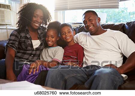 Portrait Of Happy Family Sitting On Sofa Together View Large Photo Image Stock Image - Portrait Of Happy Family Sitting On Sofa Together. Fotosearch