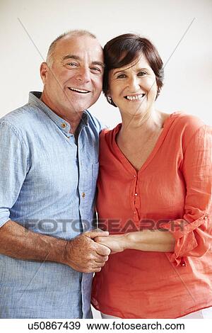 Stock Photo - Portrait Of Happy Middle Aged Hispanic Couple. Fotosearch
