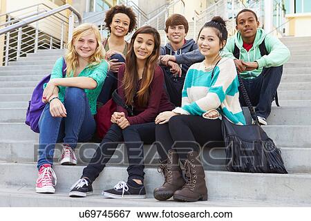 Stock Photo - Portrait Of High School Students Sitting Outside Building. Fotosearch