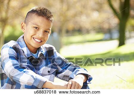 Stock Photo - Portrait Of Hispanic Boy In Countryside. Fotosearch