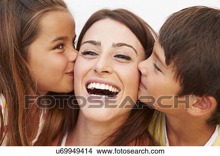 Picture - Portrait Of Hispanic Children Kissing Mother . Fotosearch