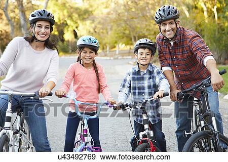 Stock Photo - Portrait Of Hispanic Family On Cycle Ride In Countryside. Fotosearch