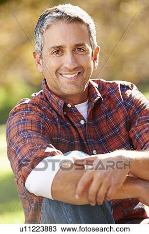 Stock Image - Portrait Of Hispanic Man In Countryside. Fotosearch
