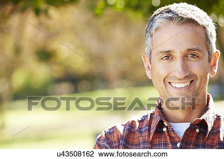 Stock Image - Portrait Of Hispanic Man In Countryside. Fotosearch