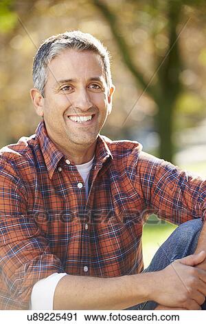 Stock Image - Portrait Of Hispanic Man In Countryside. Fotosearch