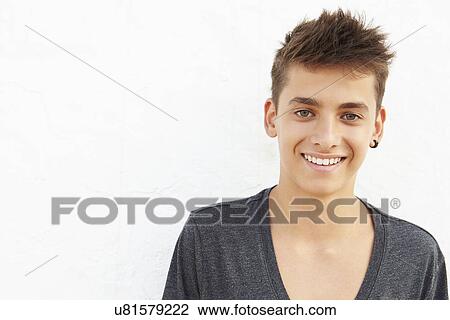 Stock Image - Portrait Of Hispanic Teenage Boy Leaning Against Wall. Fotosearch